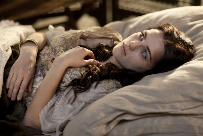 Morgana from Merlin lying in bed