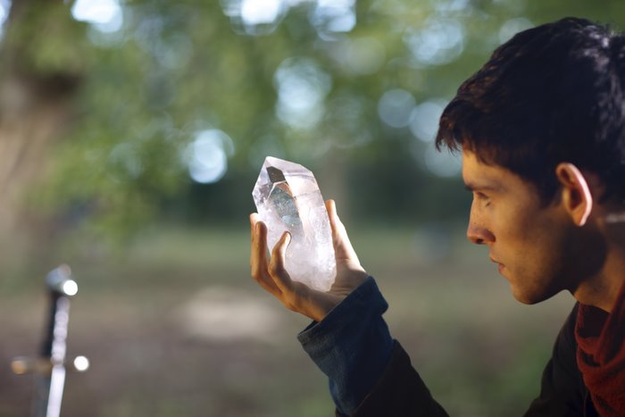 Merlin holding a crystal