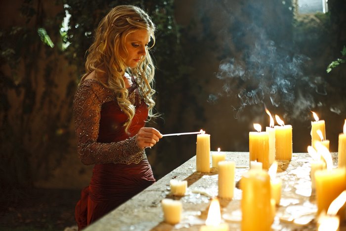 Morgause from Merlin lighting candles
