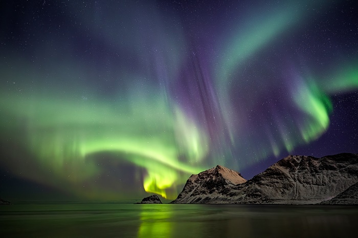 Aurora Borealis over mountains and ocean