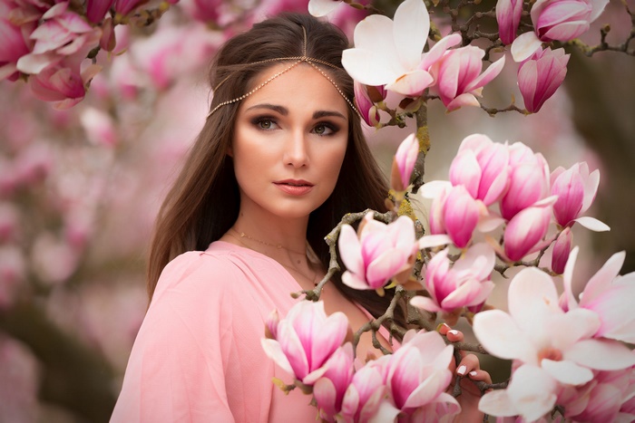 Brunette Woman Among Pink Magnolia Blossoms
