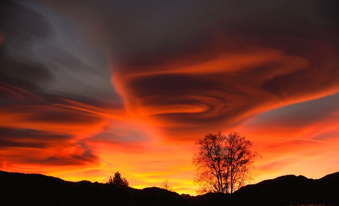 Dramatic sunset clouds over silhouetted hills