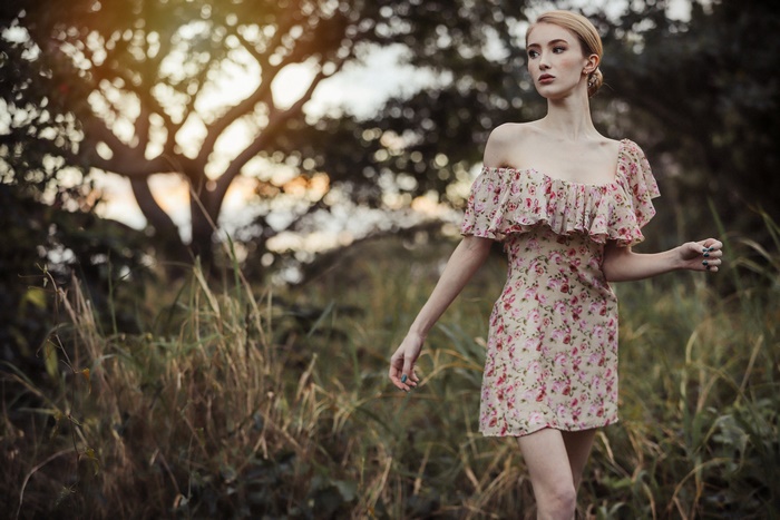 Woman in floral dress in a forest