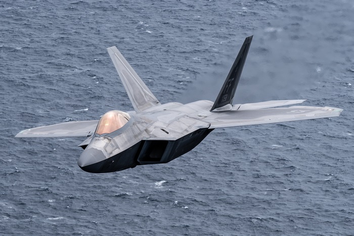 F-22 Raptor jet fighter flying over the ocean