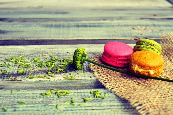 Macarons and flower on wooden table
