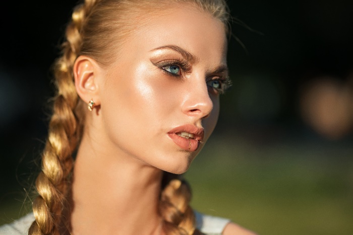 Woman with blonde braids and blue eyes