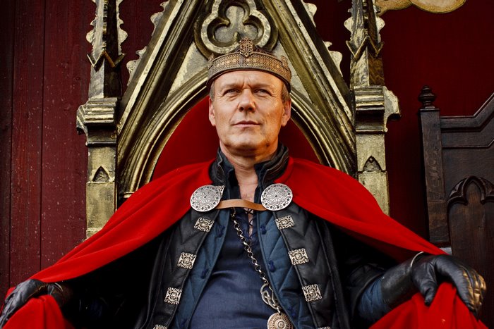 Uther Pendragon from Merlin wearing a crown and cape