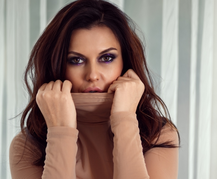 Woman with dark hair and purple eyeshadow