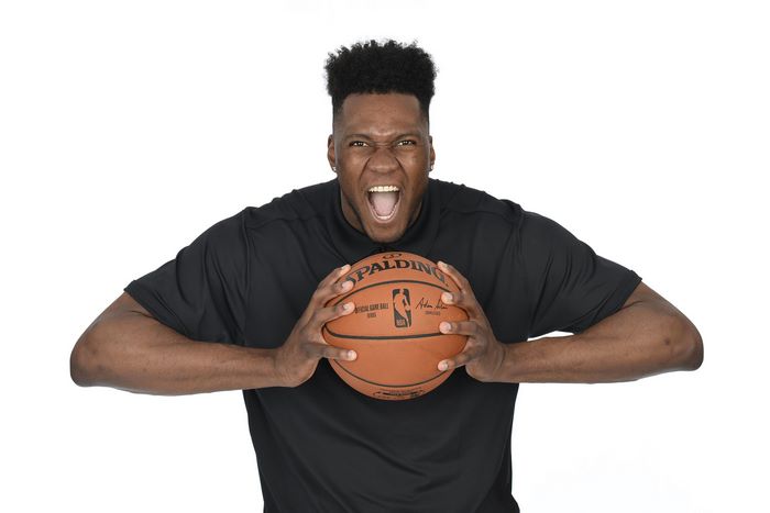 Bruno Fernando holding a Spalding NBA basketball
