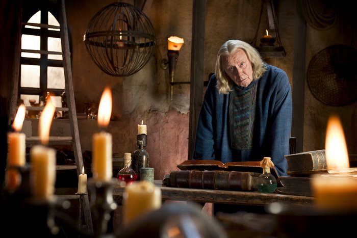 Gaius from Merlin in a dimly lit room