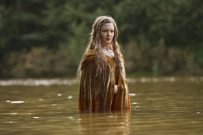 Sophia from Merlin standing in water