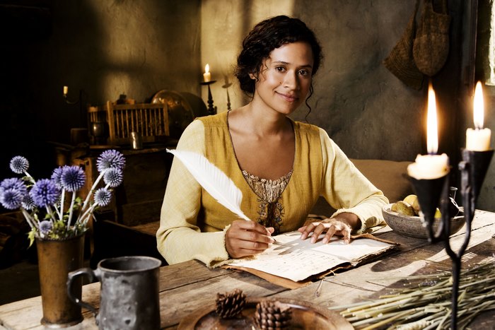 Guinevere from Merlin writing with a quill
