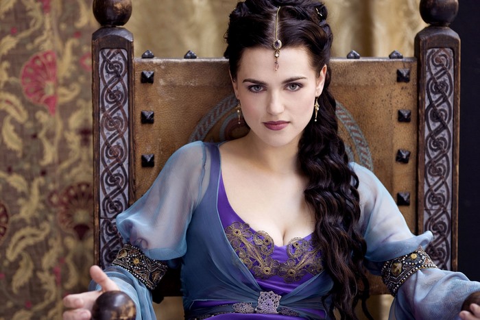 Morgana from Merlin sitting on a throne