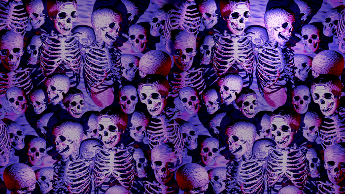 A pattern of skeletons and skulls in purple and red lighting