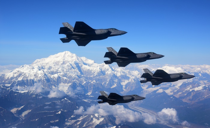 Four F-35 Fighter Jets Fly Over Snowy Mountains