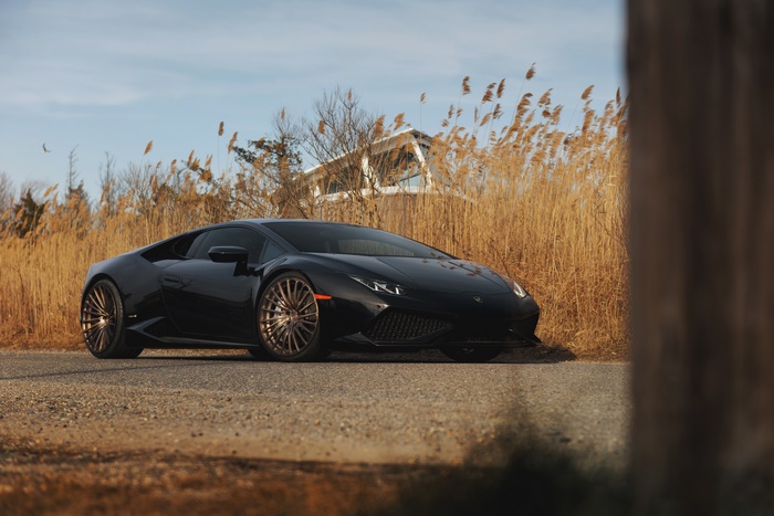 Black Lamborghini Huracan on a gravel road