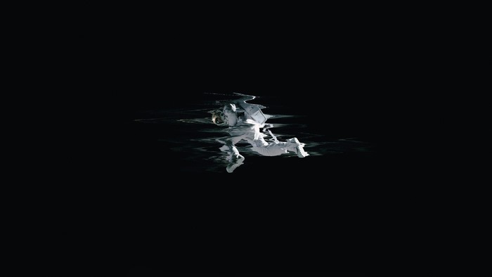 Astronaut floating in dark water