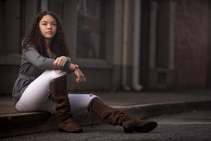 Woman Sitting in Brown Boots Outdoors