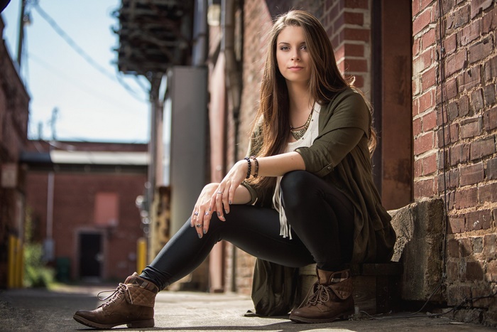 Brunette Woman Sitting Outdoors
