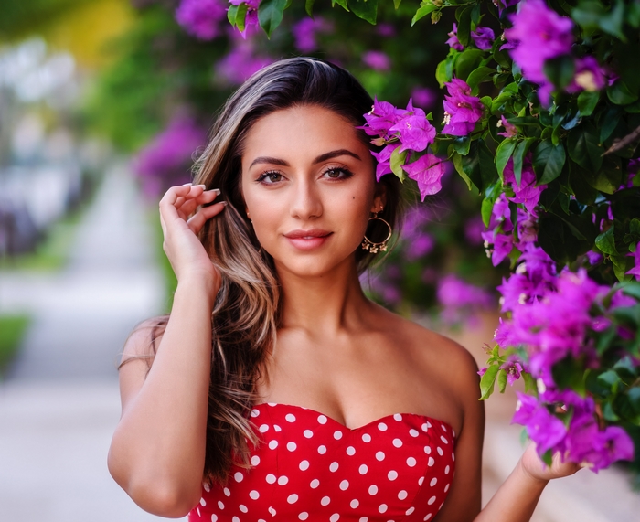 Woman with purple flowers and red polka dot dress