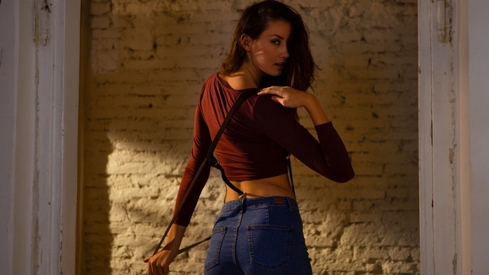 Woman in maroon top and blue jeans