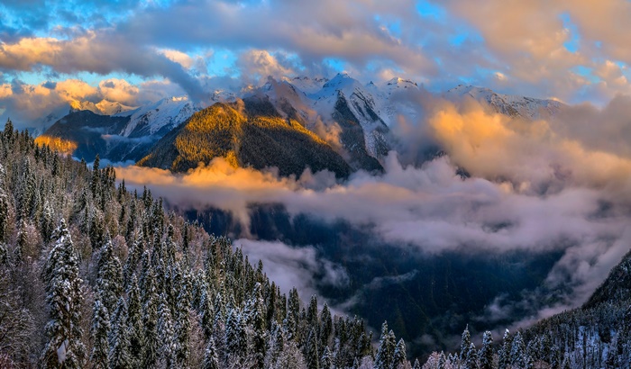 Snowy Mountains with Clouds at Sunset