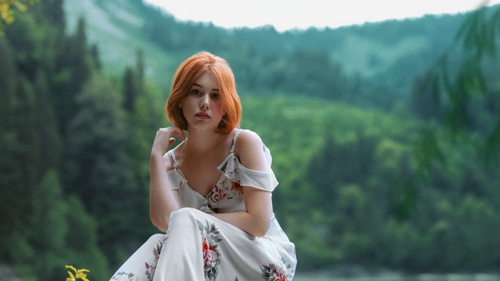 Woman with red hair in a floral dress