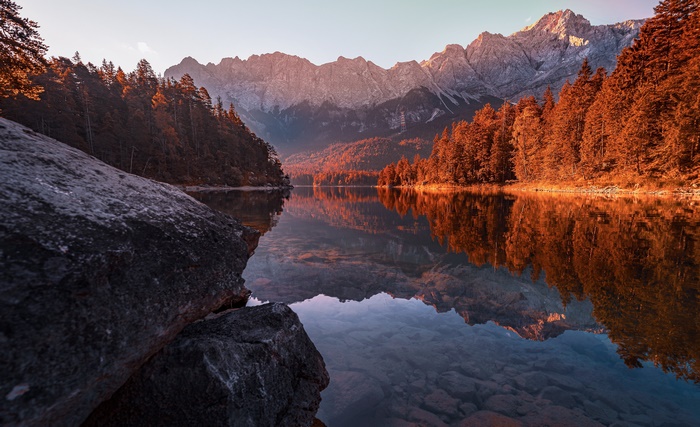 Lake reflection of autumn trees and mountains in Germany