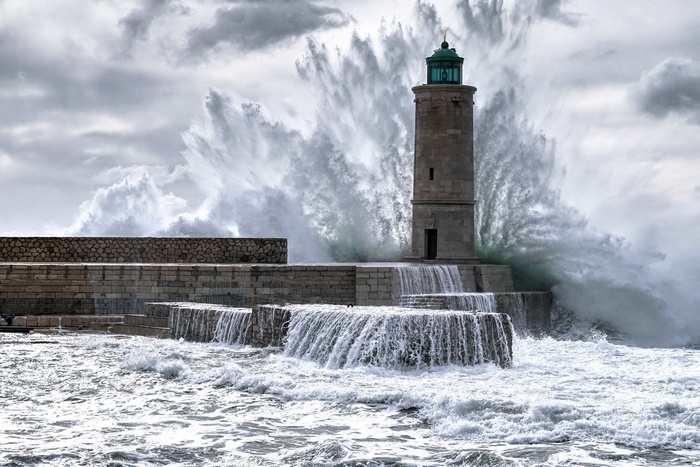Lighthouse battered by massive waves