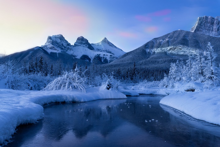 Three Sisters mountains and river in winter