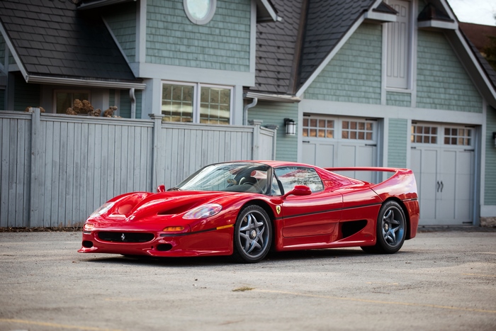 Red Ferrari F50 Supercar parked in front of a house