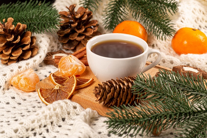 Still life with coffee, pine cones, and tangerines