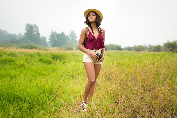Woman with binoculars in a field