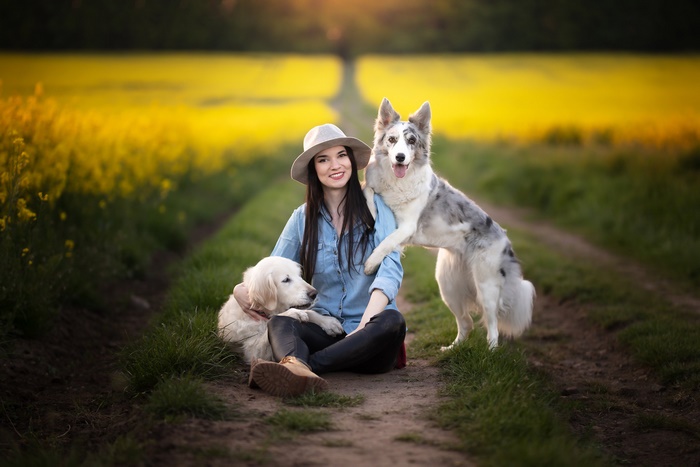 Woman with two dogs in a field