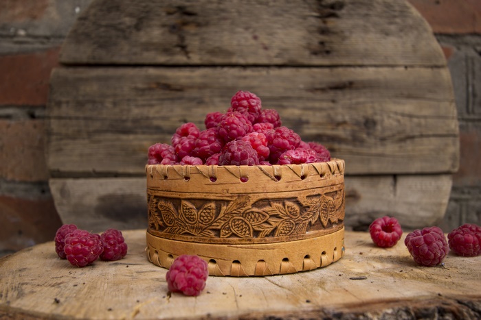 Raspberries in a decorative wooden container