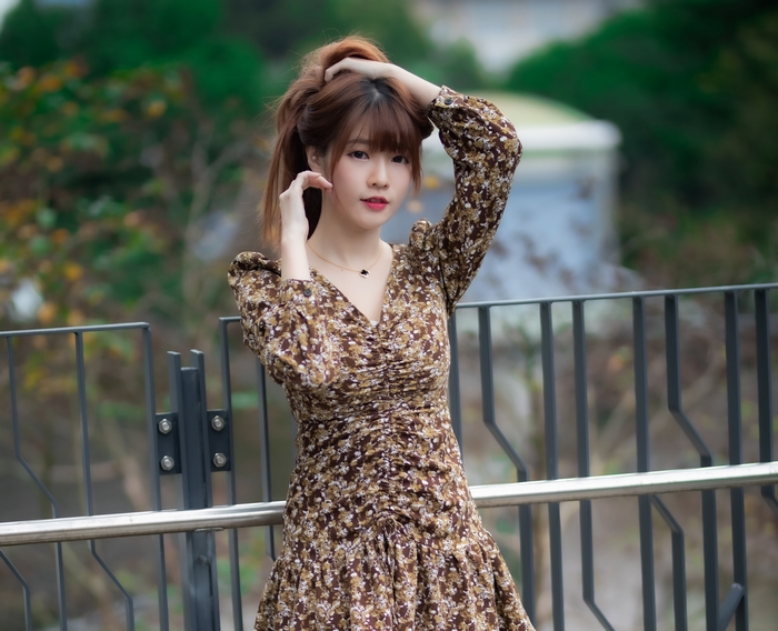 Woman in a floral dress posing outdoors