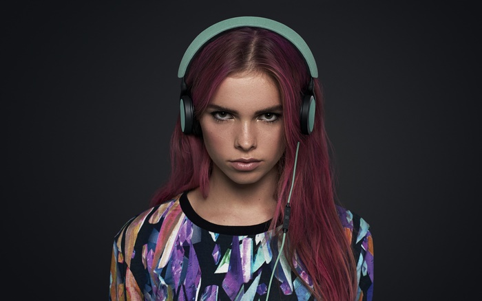 Woman wearing headphones and colorful shirt