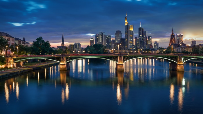 Frankfurt skyline and bridge over river at night