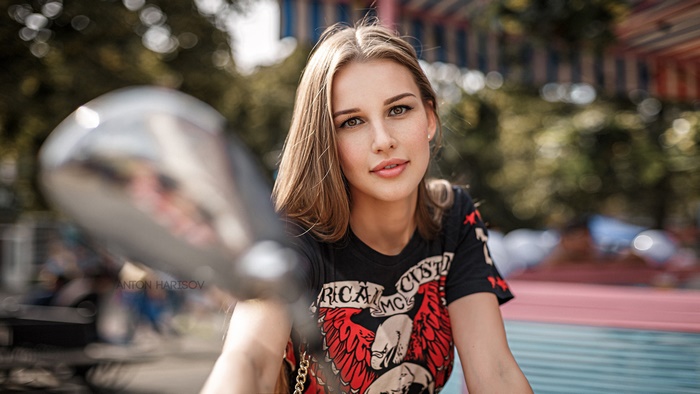 Woman with blonde hair wearing a black t-shirt