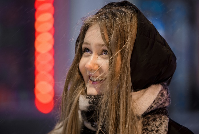 Woman with blonde hair and scarf in snow