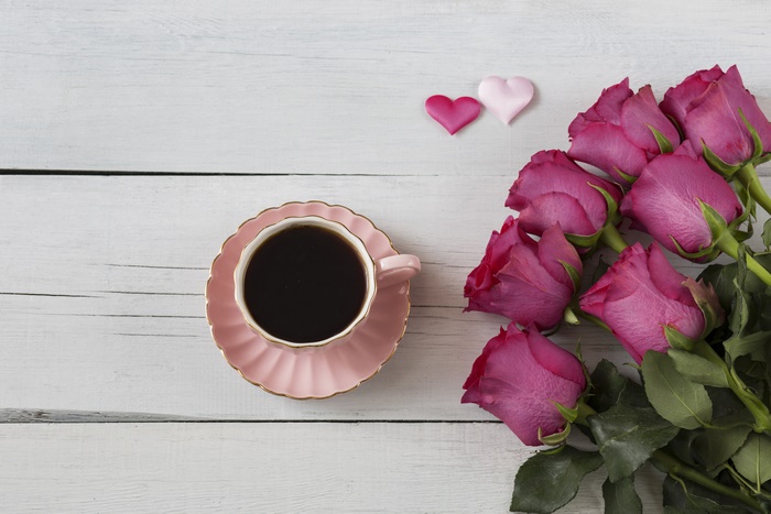 Pink roses and coffee cup with hearts