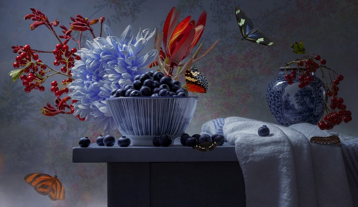 Still life with blueberries, flowers, berries, and butterflies