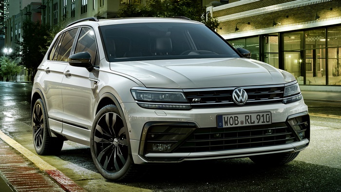 White Volkswagen Tiguan R-Line SUV on a Wet Street