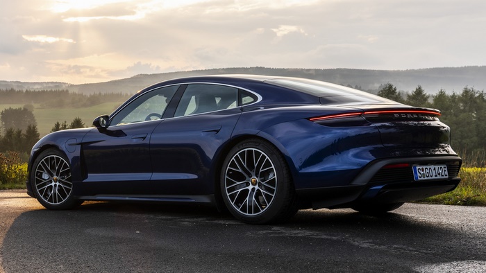 Blue Porsche Taycan Turbo electric sedan on a road