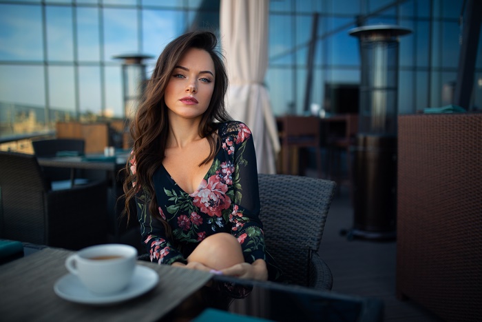 Woman with long brown hair wearing a floral dress