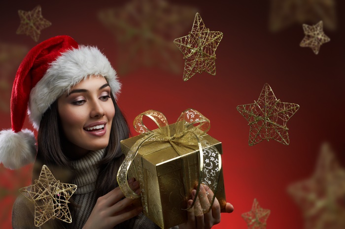 Woman in Santa Hat Holding a Gift