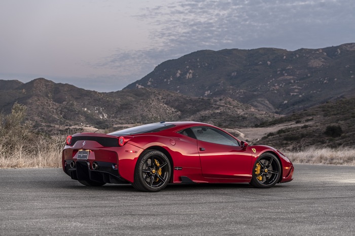 Red Ferrari 458 Speciale parked on asphalt road