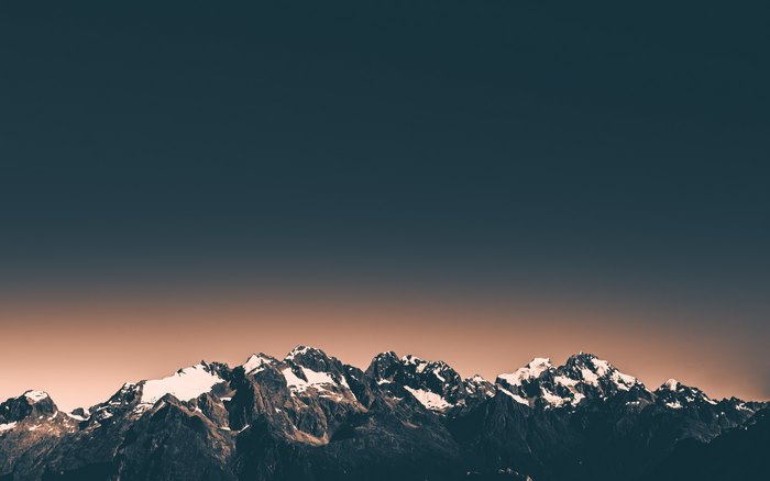 Snow-capped mountains at sunset