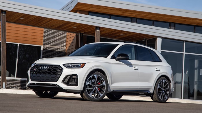 White Audi SQ5 4K parked in front of a modern building