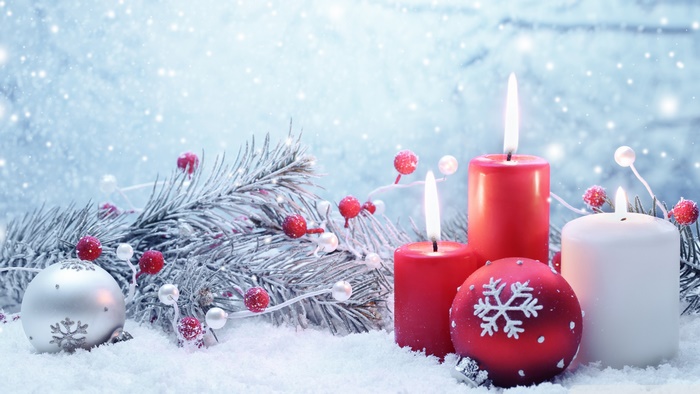 Christmas candles and ornaments in snow